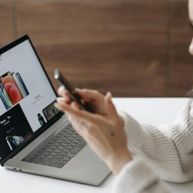 Asian woman shopping online with a laptop and smartphone at home.